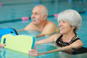 senior couple exercising in a swimming pool